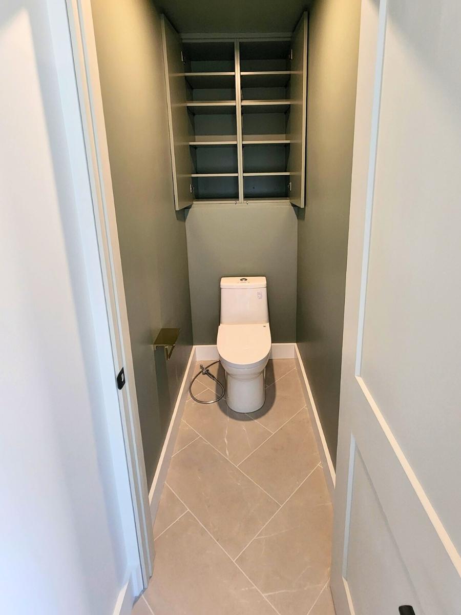 Toilet nook with storage.