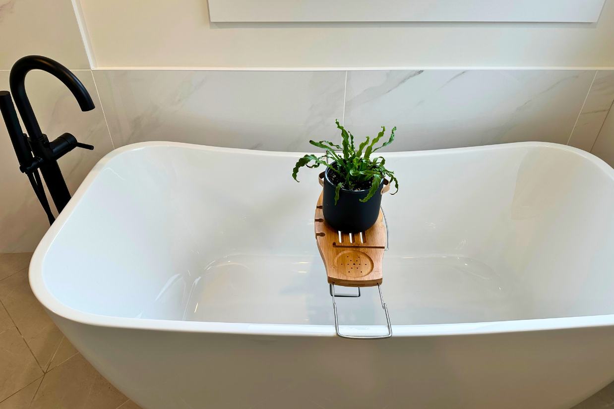 Large soaker tub with black accents.