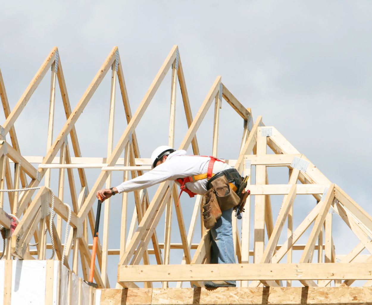 Contractor building the roof of a custom home.