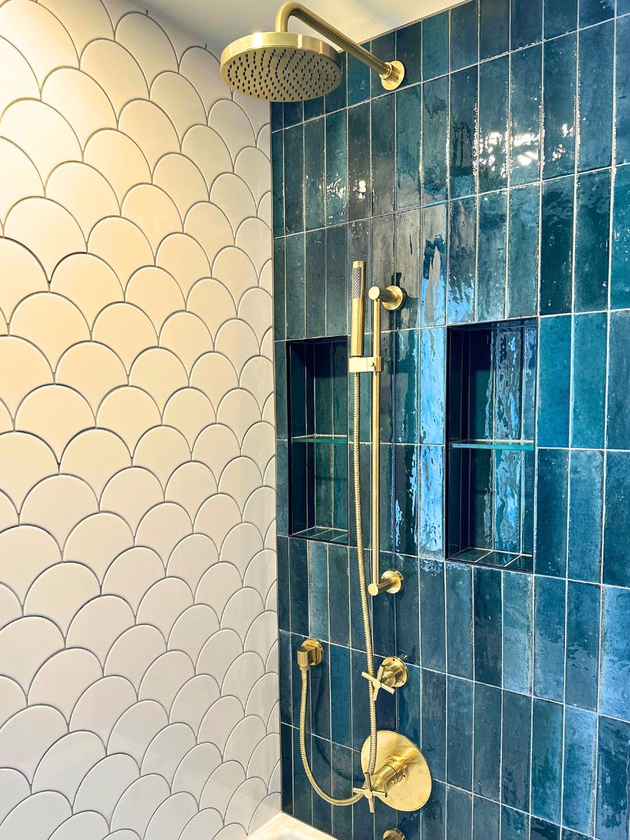 Closeup of gold hardware on renovated shower.