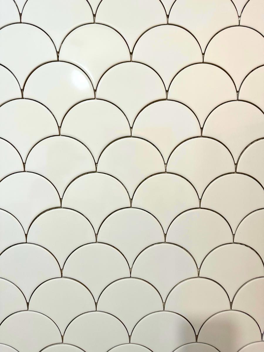 Close up of white mermaid tile pattern.