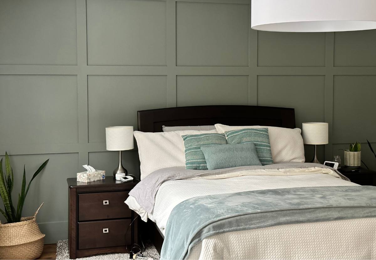 Sage green feature wall of Ottawa bedroom.