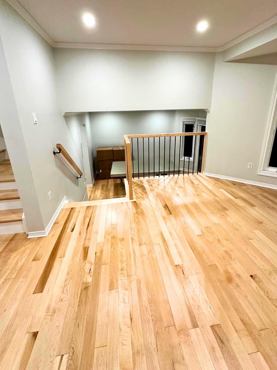 Hardwood flooring and ceiling smoothened during home renovation.