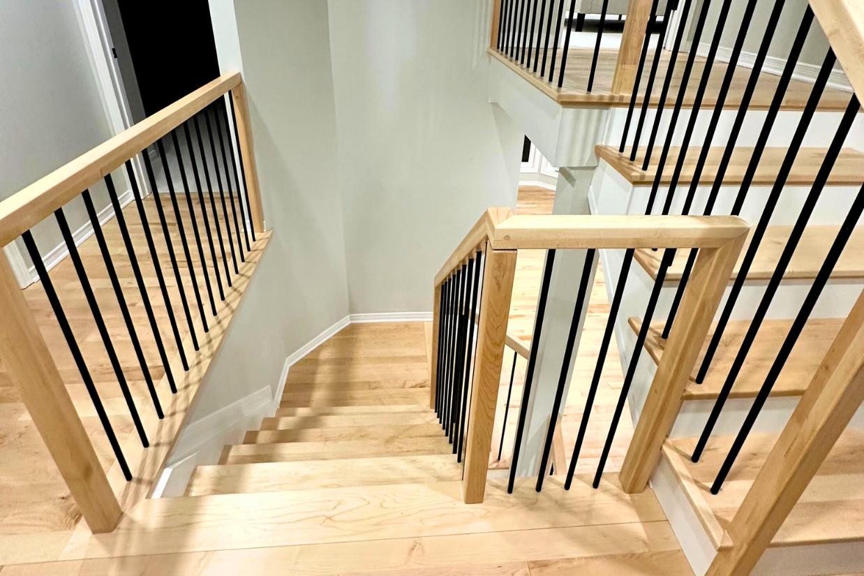 Shot looking down a set of renovated hardwood stairs in Ottawa home.