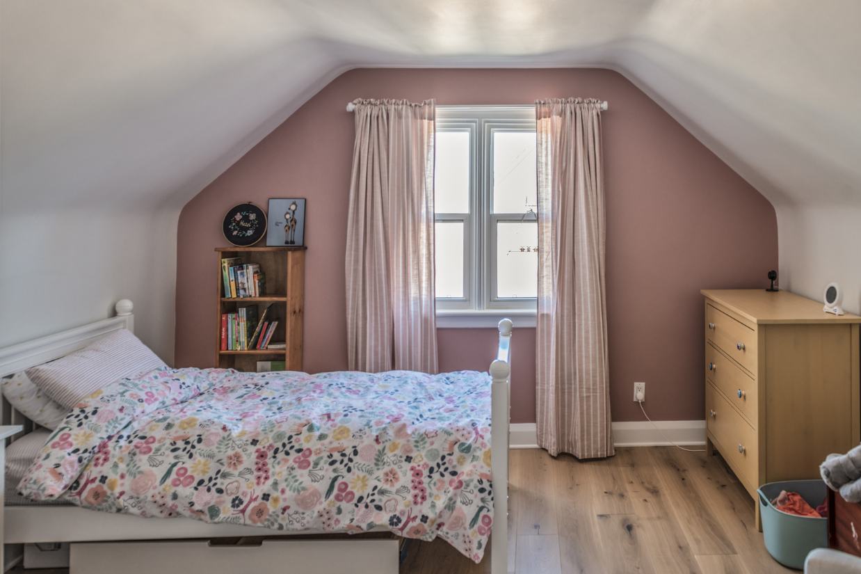 Renovated girls room with pink feature wall.