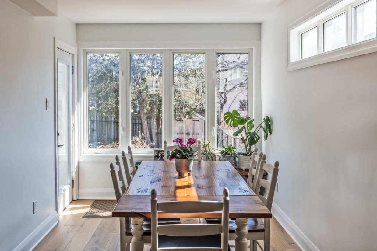 Renovated dining room with large bay window and privacy window.