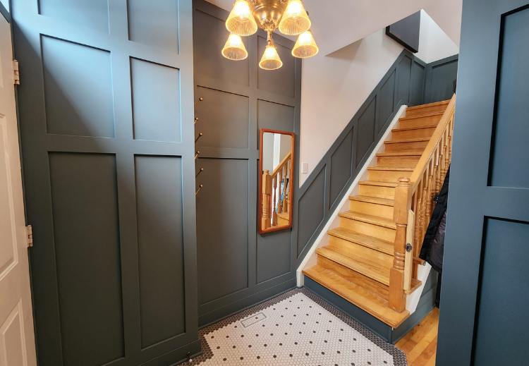 Ottawa entryway project featuring wainscotting and dark blue paint.