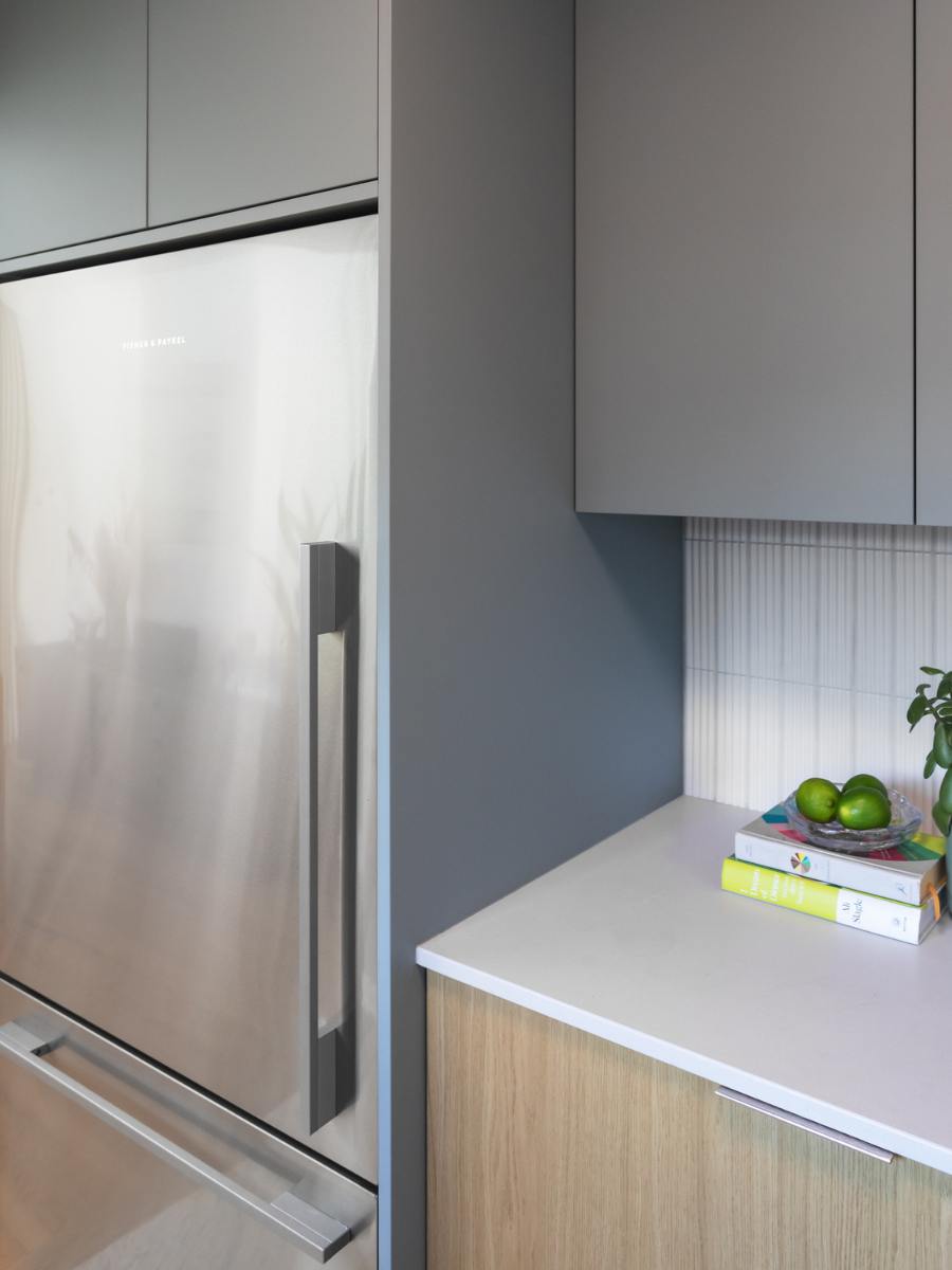 Close up of nook near large stainless fridge.