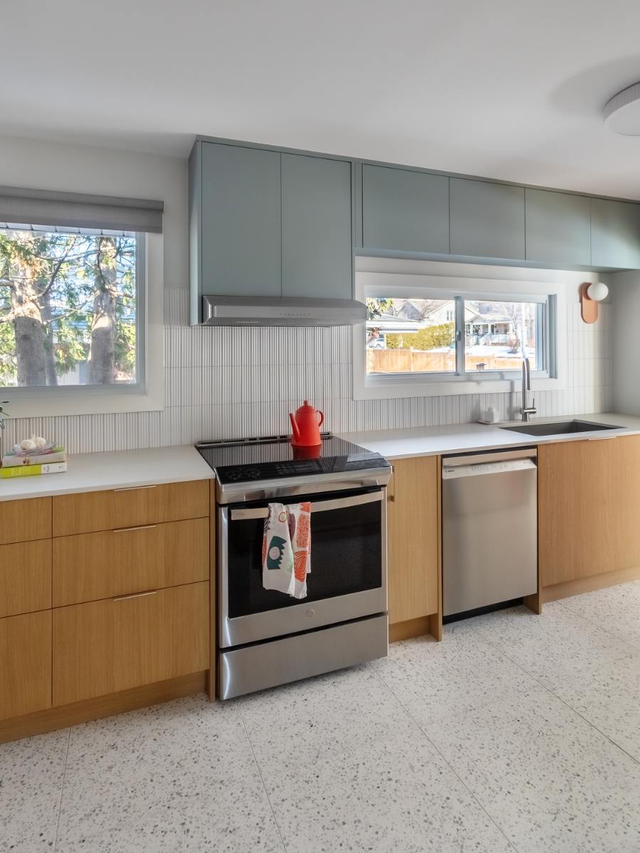 Shot of renovated kitchen facing stove and dishwasher cabinets.