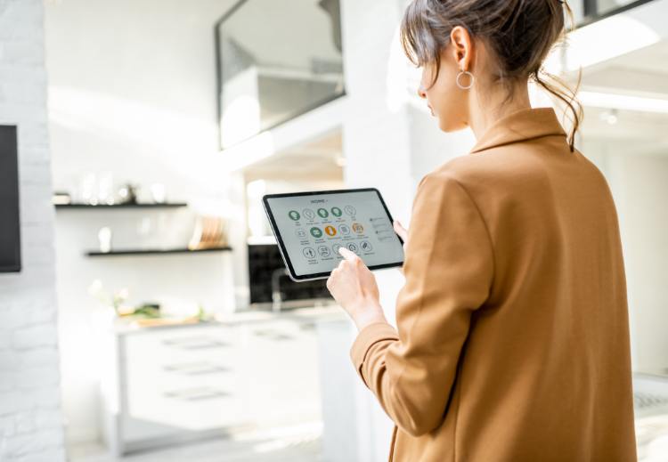 Woman using table to control smart home device.